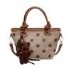 Bolsa transversal de nicho nova, elegante e estilosa 2026, bolsa de mão pequena de alta qualidade, bolsa de balde de bolinhas, bolsa de ombro