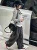 Ropa infantil estilo coreano 2026 colección otoño: conjunto de top a rayas con capucha de dos piezas de imitación y pantalones elegantes de pierna ancha para niñas