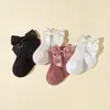 Nuevos calcetines largos de rayas de color sólido para niños y niñas, algodón-poliéster antideslizantes con parte superior de burbuja, calcetines de media pantorrilla con lazo para bebé al por mayor