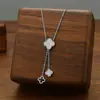 Collar de acero de titanio con borlas y trébol de venta caliente transfronteriza europea y americana para mujer, cadena de clavícula con diseño de lujo de concha de flor de cuatro hojas dorada