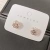 Pendientes de botón con diseño de flor de rosa de lujo y luz para mujer, con aguja de plata S925, pequeños y exquisitos pendientes huecos, pendientes de temperamento simple.