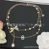 Cadena de suéter con letra doble C inspirada en Chanel de estilo transfronterizo 2026, auténtica con etiqueta, lazo de perlas, venta al por mayor directa de Chanel
