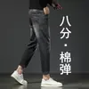 Jeans elásticos de 8/9 de largo para hombre Guangzhou Xintang, modernos y versátiles para primavera y otoño, de moda para personas bajas de 160 cm