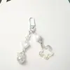 Nuevo llavero colgante acrílico hueco de estrella de cinco puntas con brillo para coche, accesorio de campana bicolor crema, accesorios para bolso