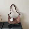 Bolso de diseñador de nicho transfronterizo para mujer, nuevo modelo 2026, bolso de hombro retro simple, bolso tipo dumpling de lujo ligero, bolso cruzado versátil