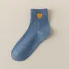Calcetines Zhuji calcetines de algodón color liso calcetines para mujer primavera y otoño calcetines para dama bordado de amor absorbentes del sudor estilo académico medias al por mayor