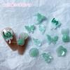 Paquete de material para accesorios de uñas estilo antiguo mariposa luminosa Concha accesorios para uñas jade transparente hielo material para uñas limpio al por mayor