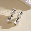 Brincos de Tarraxa Flor Gota d'Água com Strass Cruzados Europeus e Americanos Temperamento Exagerado Versátil Leve Luxo Sensação de Alta Qualidade Acessórios de Brincos para Mulheres Atacado
