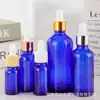 Botella de Vidrio Azul para Aceite Esencial al por Mayor 20ml Botella de Esencia 30ml Botella con Gotero de Punta de Spray Plástica a Prueba de Luz