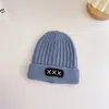 Otoño e Invierno Corea del Sur gorro de lana tejido para bebé niños y niñas parche de curling gorro de punto cálido de todos los partidos color liso moda