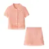 Fábrica de Ropa para Mujer Transfronteriza Venta al por Mayor 2026 AliExpress INS Conjunto de Chaqueta de Punto de Manga Corta con Borlas + Minifalda de Cintura Alta