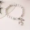 Venda transfronteiriça pulseira de asas de anjo de pérola cruz oca pulseira elástica de amor pulseira de batismo fabricantes de joias