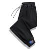 Pantalones casuales para hombre, primavera y otoño, nuevos pantalones deportivos de nueve dedos, holgados y a la moda para jóvenes, pantalones deportivos para hombres jóvenes.