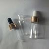 Botella de plástico PET transparente de 15 ml con gotero de emulsión de aceite esencial, con cabezal de goma brillante de aluminio electroquímico dorado y plateado.