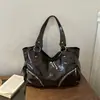 Bolsa Tote de Ombro Manual de Grande Capacidade Estilo Preguiçoso Personalidade de Motocicleta Europeia e Americana Textura Casual Coreana 2026