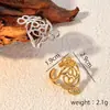 Venta caliente chapado en oro de 18 quilates sin decoloración presión de aceite temperamento elegante acero inoxidable de alta calidad línea retorcida anillo abierto