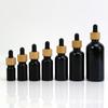 Botella Negra de Aceite Esencial 100ml Tapa de Bambú Vidrio Plástico Cabezal Gotero Botella Vacía Botella Dispensadora de Cosméticos Moderna Elegante