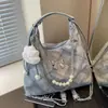 Bolsa feminina popular transfronteiriça de grande capacidade, moderna e de alta qualidade, com alça de ombro e mochila de laço, bolsa de axila com design de nicho