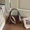 Bolso bandolera retro de diseño de nicho texturizado para mujer 2026 verano nueva moda bolso de mano liso simple bolsa tote pequeña