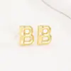 Pendientes de letras de burbuja lisas con baño de cobre y oro real transfronterizos, moda, temperamento, Joker, nuevos pendientes exquisitos, venta al por mayor