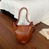 Moda transfronteriza 2026 nuevo bolso cubeta de nicho para mujer, bolso de hombro cruzado de sensación simple vintage de alta gama