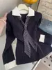 Diseño coreano sentido color negro bloques de color falso dos piezas lunares corbata suéter de punto de manga larga para mujer absolutamente impresionante suéter top interior