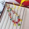 Cadena para teléfono móvil con cuentas de cristal y explosiones de moda de Año Nuevo, colgante de aleación con accesorios de la fortuna, colgante para bolso vivo y llave.