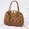 Bolso tipo concha estampado para mujer 2026 nuevo bolso de hombro decorativo casual mini bolso pequeño con colgante bolso de mano de moda