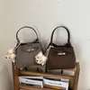 Bolso de cubo de mano estilo coreano para mujer, nuevo bolso de hombro vintage 2026 para el trabajo y los desplazamientos, bolso cruzado de mano