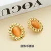 Moda europeia e americana nicho brincos vintage aço titânio banhado a ouro 18K temperamento geométrico pedra natural olho de gato sol brincos mulheres