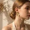 Pendientes de flor de ginkgo tridimensionales versátiles de moda transfronteriza europea y americana, tachuelas de pétalos de hilo de oro geométricas exageradas únicas