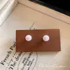 Aretes de perlas estilo bun vintage francés para mujer, diseño de nicho, aretes de alta gama, exquisitos, a la moda, accesorios para orejas versátiles al por mayor