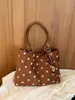 Bolsa de mano transfronteriza con lunares esmerilados para mujer, nuevo estilo 2026, diseño único, ligera, adecuada para ir al trabajo y con gran capacidad