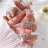 Artistas de uñas de moda joyería de circonita flor giratoria molino de viento tridimensional súper brillante cristal de circonita mariposa decoración de uñas fabricantes
