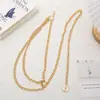 Venta al por mayor de fábrica otoño e invierno estilo coreano collar simple elegante de longitud media doble capa moneda conmemorativa cadena para suéter de mujer