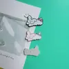 Lazo de Dibujos Animados Perro Blanco y Negro Accesorios Pequeños Zuecos DIY Funda de Teléfono Juguete Accesorios para Pasador de Pelo Decoración Parches