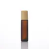 Botellas roller de vidrio ámbar de alta calidad al por mayor de 10 ml con tapas de grano de madera, ideales para aceites esenciales, perfumes y dispensación en tamaño de muestra