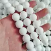 Venta al por mayor Cuentas Redondas de Porcelana Ultra Blancas 4mm6mm8mm10mm12mm14mm Cuentas Perforadas de Porcelana Cuentas de Vidrio Blancas