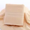 Toalla de seda de color puro dorado toalla facial de pareja lisa suave absorbente para adultos engrosada al por mayor toalla de algodón puro