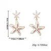 Pendientes de Estilo Vacacional Nuevo Océano Transfronterizos Europeos y Americanos con Forma de Estrella de Mar, Perlas, Goteo de Aceite y Tachuelas de Diamantes Pendientes Bohemios Exquisitos