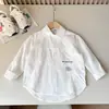 Ropa Infantil Primavera y Otoño 2026 Niños Algodón Lavado Suave Ropa de Trabajo Camisas Manga Larga Venta al por Mayor