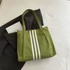 Bolso tote de lona de gran capacidad estilo casual coreano 2026 para mujer, nuevo bolso de mano de moda para estudiantes, adecuado para la escuela y el trabajo