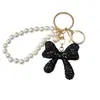 Llavero de Lujo Completo con Diamantes y Lazo de Cristal Sensación de Alta Gama Colgante de Bolso con Cadena de Perlas Tendencia de Moda Colgante de Pedrería