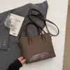 Bolso de mano tipo cubo nuevo de primavera 2026, transfronterizo, estilo vintage simple, de alta gama, moderno, para ir al trabajo, bolso de hombro cruzado de moda