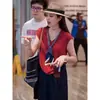 Camisa de manga corta ligeramente lujosa con cuello de diseño de cinta para mujer, nueva moda de verano, top elegante y versátil