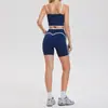 Nuevo conjunto deportivo transfronterizo para mujer: Shorts de fitness de tiro alto que levantan los glúteos, sujetador de yoga de alta elasticidad con sensación de segunda piel y hermoso diseño en la espalda