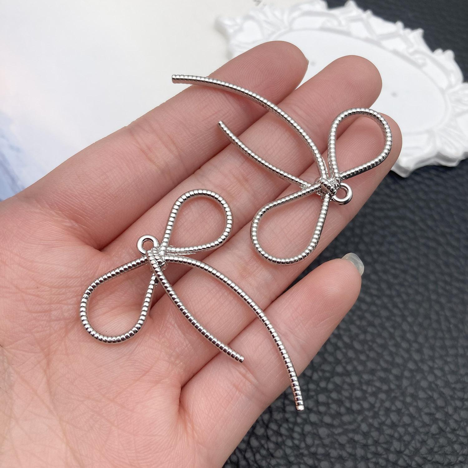 21397-DL-白K保色锌合金长麻绳蝴蝶结44x36mm-