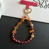 Cadena Creativa para Teléfono Móvil con Temática de Texto, Cuentas de Cristal de Aleación, Correa de Muñeca, Colgante Rojo de Año Nuevo