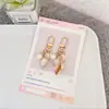 Llavero colgante de aleación creativa con forma de corazón, perla y concha, accesorios para bolso, adornos de joyería metálica, regalos pequeños al por mayor