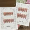 Un par de uñas postizas [Diseño de Flor Brillante], puras y seductoras, degradado rosa melocotón, talladas intrincadamente, con detalles de diamante triturado y purpurina plateada, hechas a mano